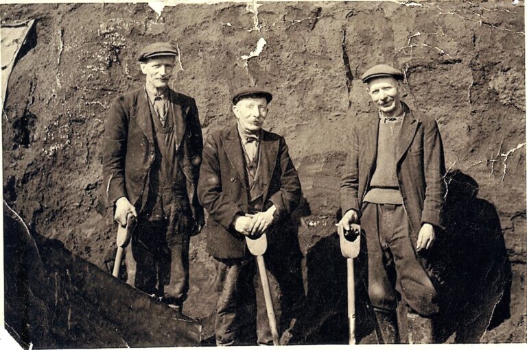 3 men in red ore quarry